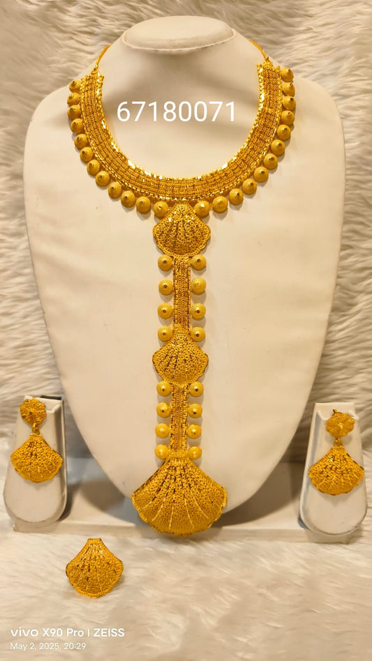 Gold necklace and earrings set on a white mannequin bust with visible brand logos.