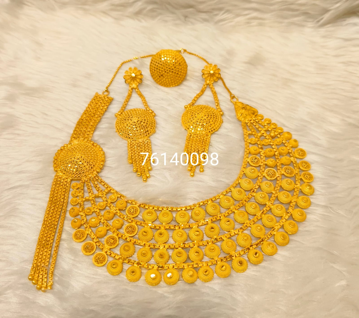 Gold necklace set on a light background