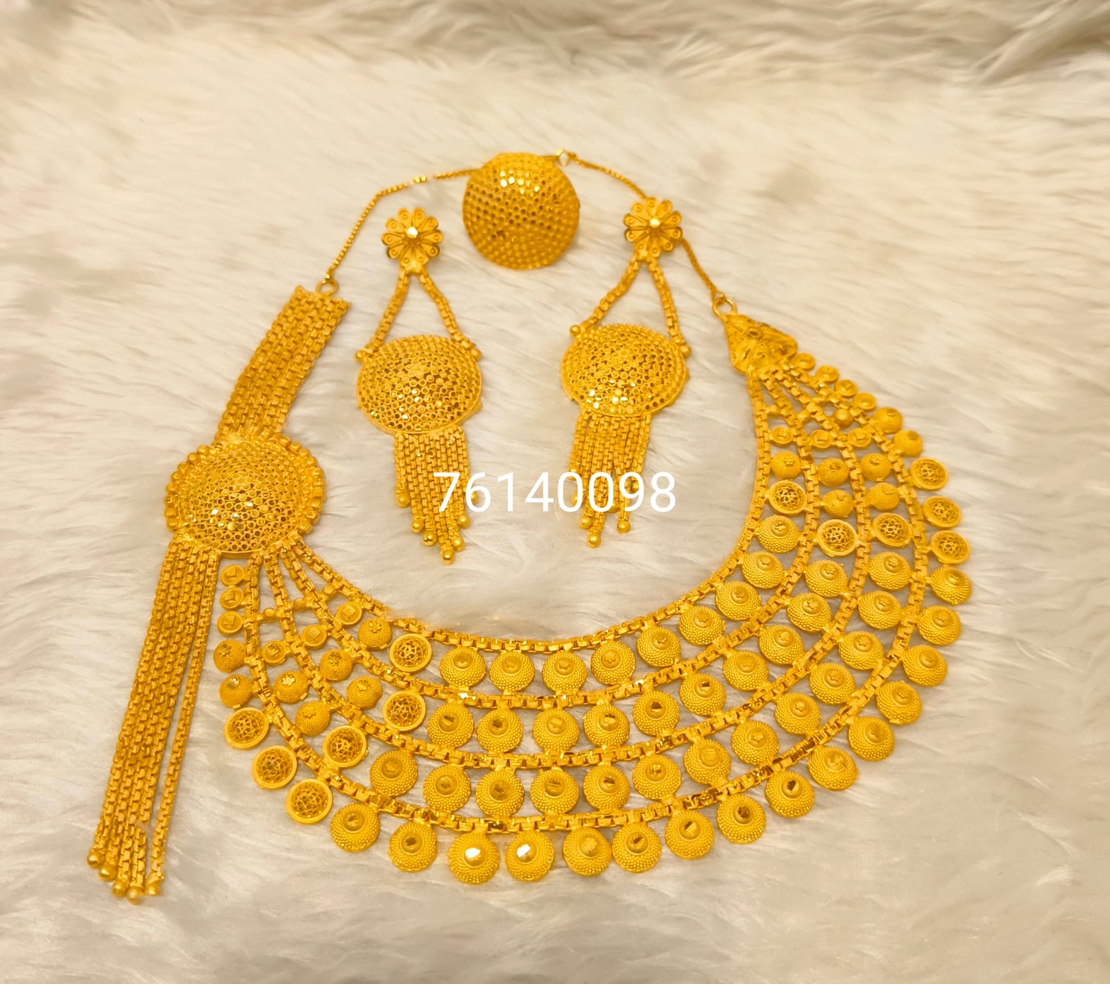 Gold necklace set on a light background